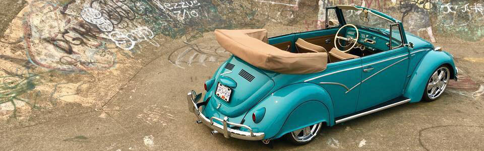 A teal VW beetle with a tan leather custom interior.